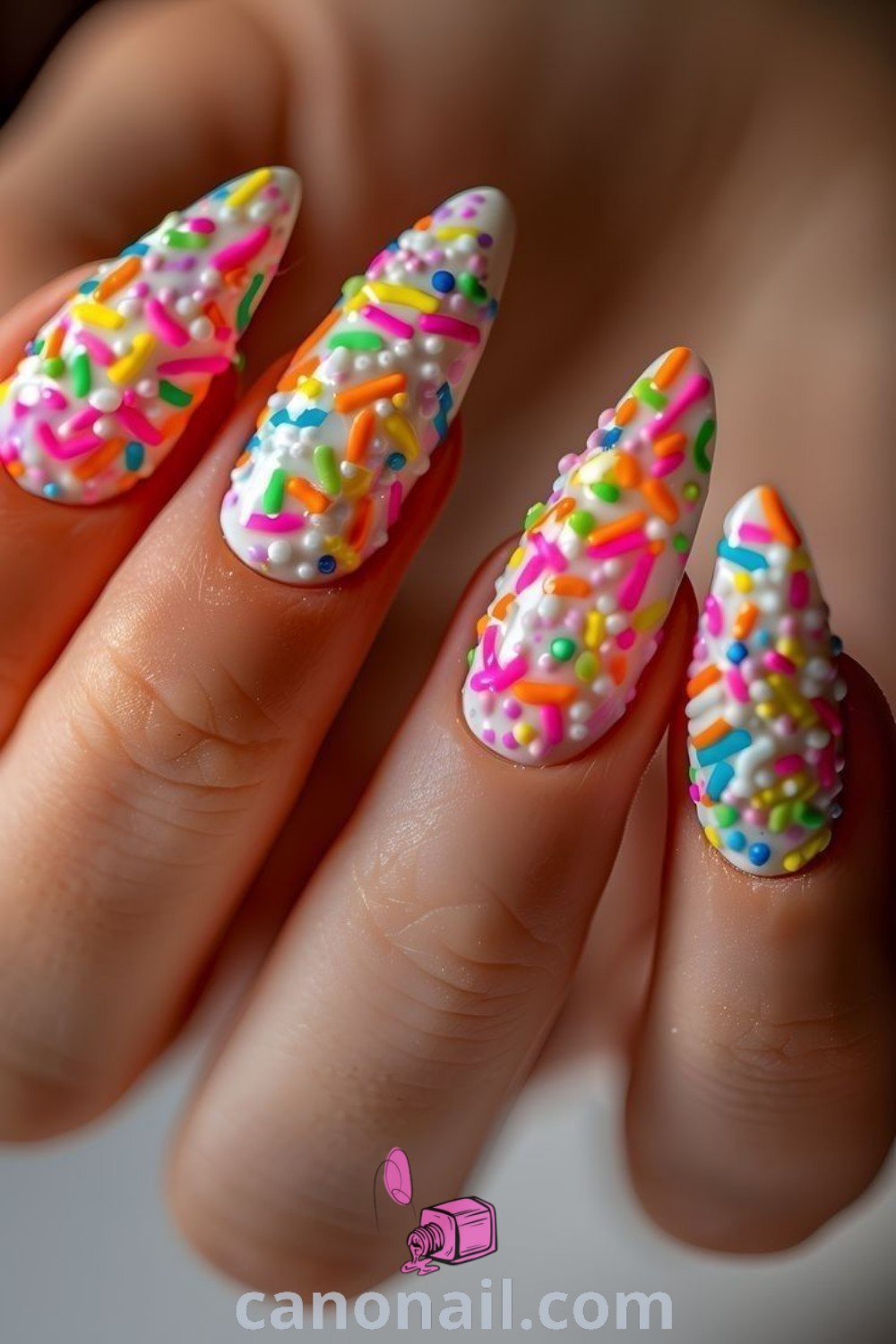 Spring nails in vibrant almond shape with sprinkle nail art, candyland designs, and fun summer inspirations. Ideal for celebrating the season with beautiful nail ideas. Discover more inspiration at canonail.com.