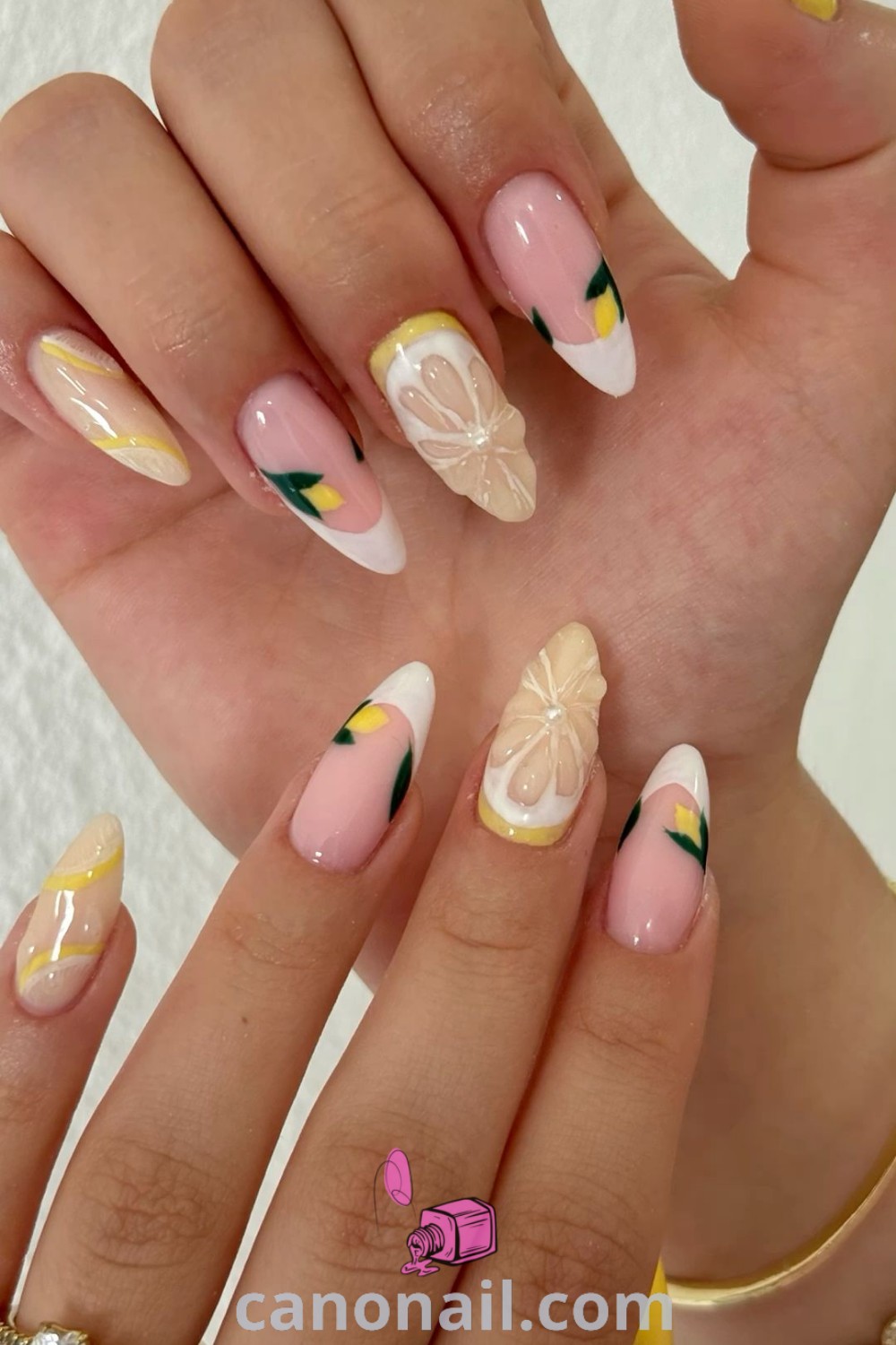 Spring nails featuring almond-shaped designs with lemon gel nail art, citrus colors, and beautiful nail inspiration. Trendy summer nails showcase oranges and lemons for a fresh look. Explore more stunning nail ideas at canonail.com.