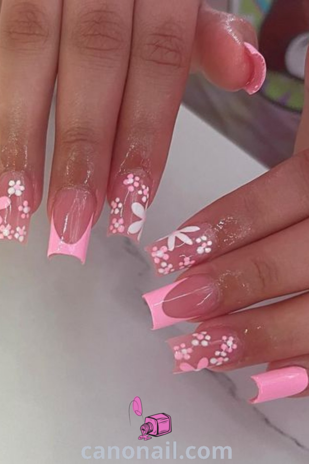 Spring nails designed in a square shape featuring pretty pink accents and floral patterns perfect for spring. Discover modern nail ideas and stunning nail inspiration for a trendy and elegant manicure at canonail.com.