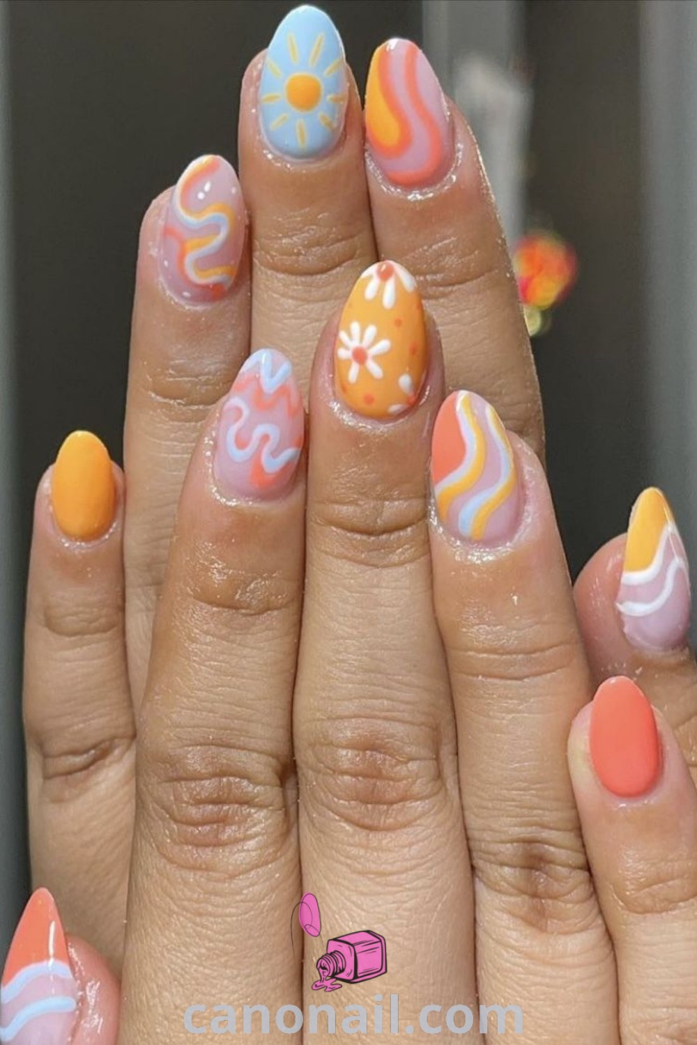 Spring nails featuring groovy nail art, retro short nails, and bright colorful designs on almond-shaped nails. Perfect for spring trends, these manicures offer nail inspiration for a funky vacation vibe. Discover more about these beautiful nails at canonail.com.