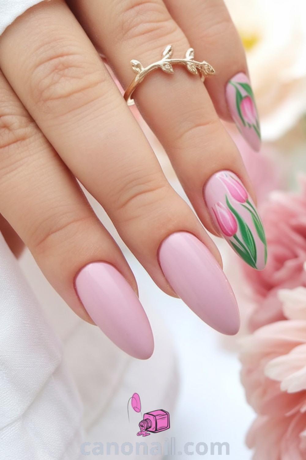 Spring nails featuring minimalist designs with tulips and pink hues on almond-shaped nails. Ideal for spring celebrations like Easter, these modern nail designs offer beautiful nail inspiration. Discover more stunning nail looks at canonail.com.