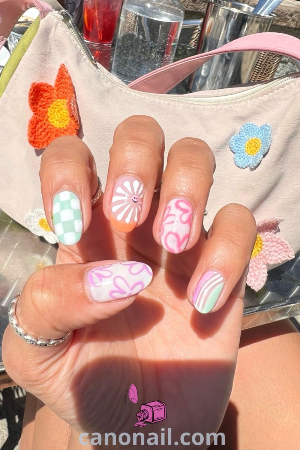 Spring nails in almond shape featuring checker flower designs, cute pastel colors, and trendy acrylic styles. Ideal for creating stunning nail looks and elegant nail art. Discover beautiful nail ideas at canonail.com.