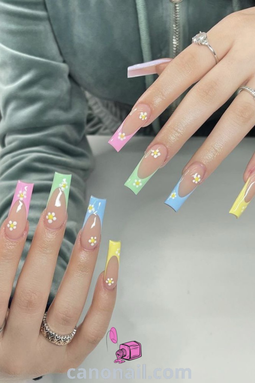 Spring nails with square shape featuring colorful French tips, rhinestones, and Easter-inspired designs for a stunning and elegant manicure. Enjoy beautiful and modern nail ideas at canonail.com.