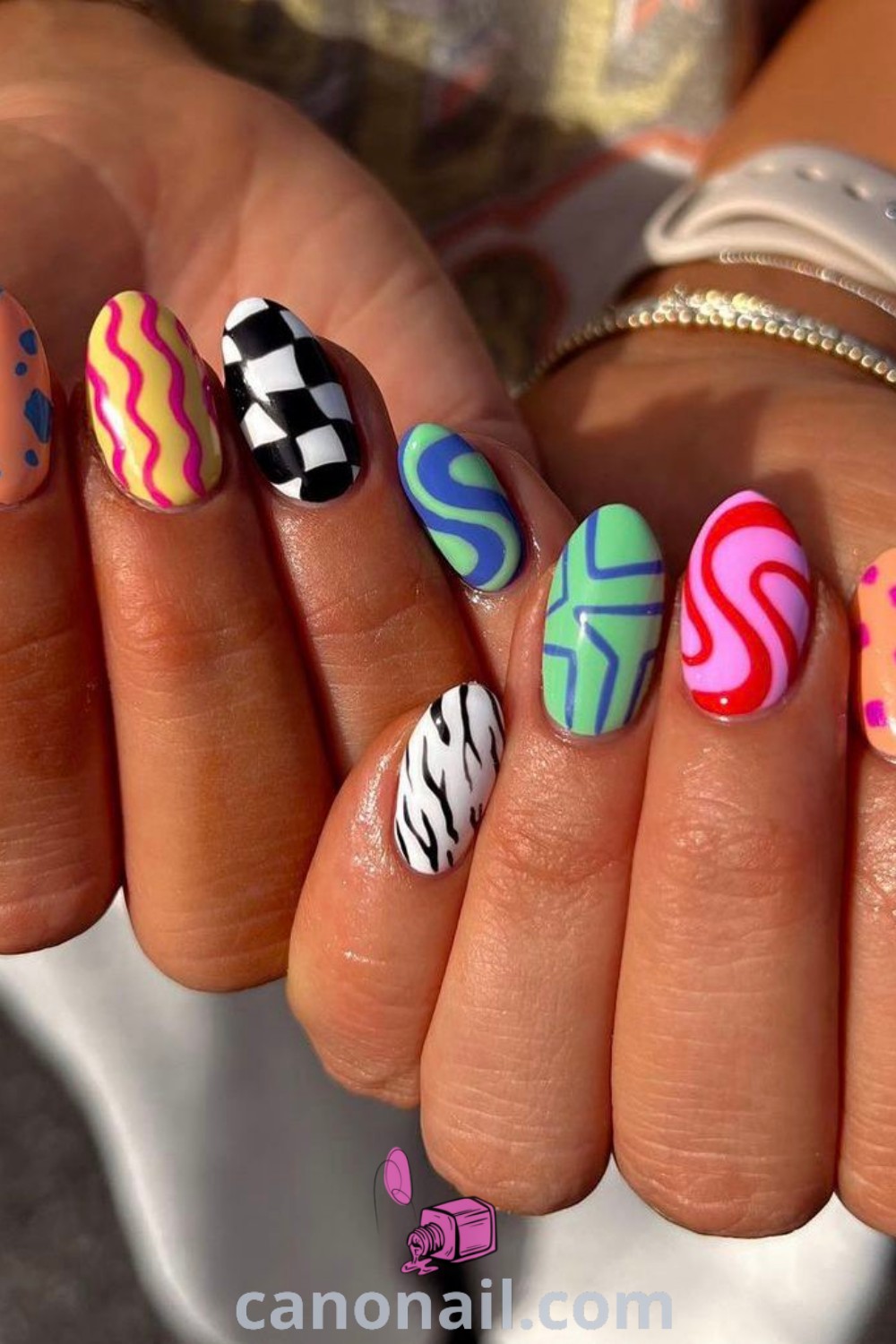 Spring nails on almond shapes showcasing colorful fun designs, mismatched color schemes, smiley motifs, and kaleidoscope nail art. Experience trendy and beautiful nails that capture seasonal vibes. Discover modern nail ideas at canonail.com.