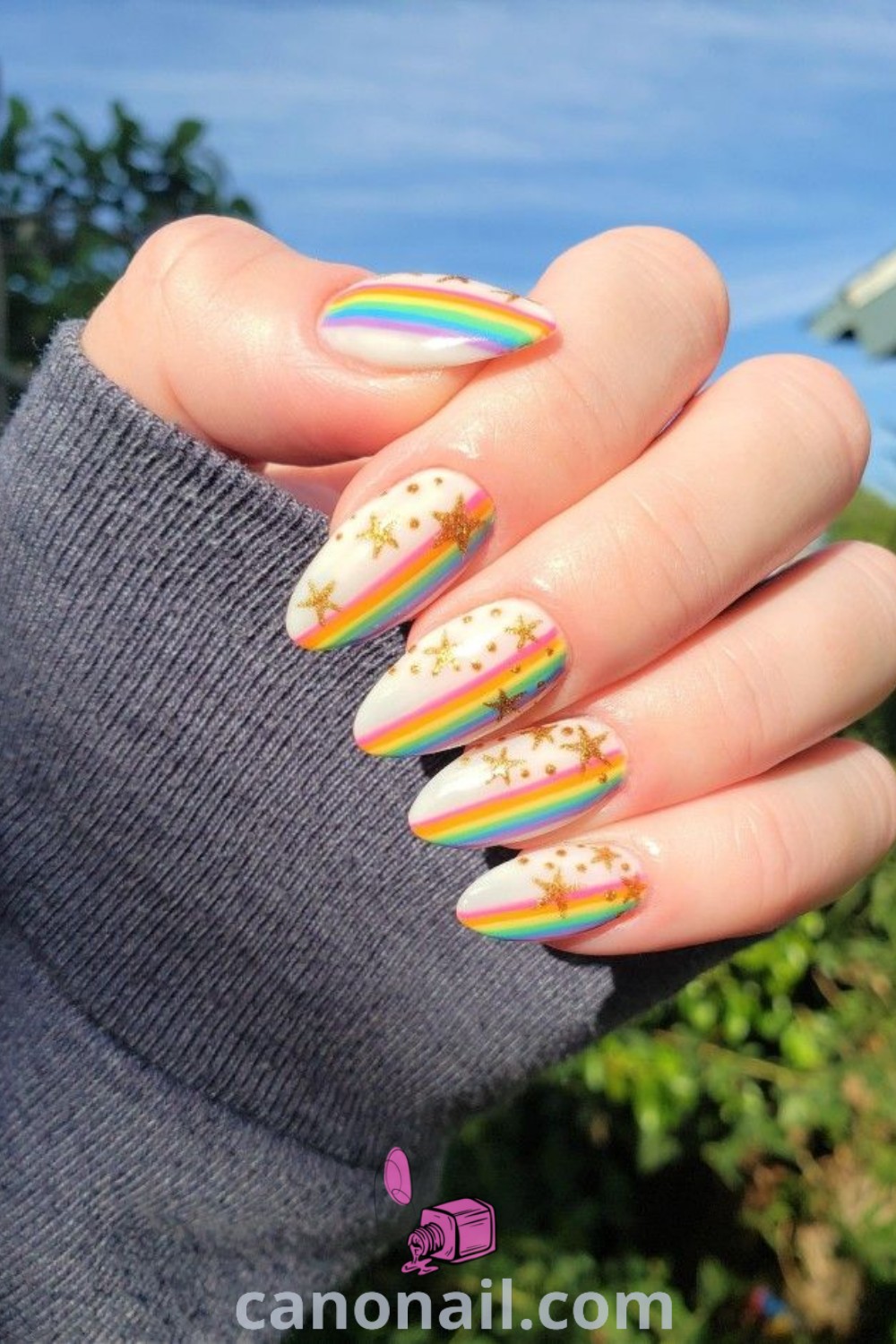 Spring nails in an almond shape featuring rainbow star designs, Pride nail art, and stunning nail looks. An elegant and colorful manicure perfect for celebrating individuality. Explore more nail ideas at canonail.com.