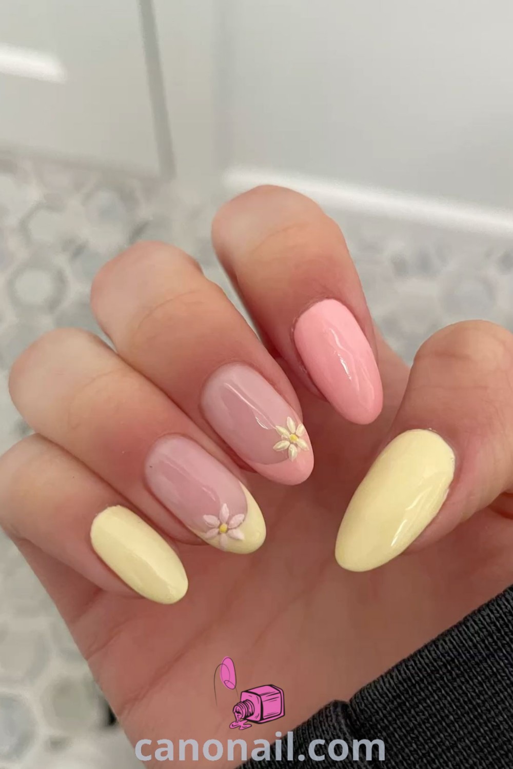 Spring nails featuring almond-shaped designs with pastel colors, floral bouquets, and pink and yellow accents. A perfect blend of chic and cute for spring nail inspiration. Discover more at canonail.com.