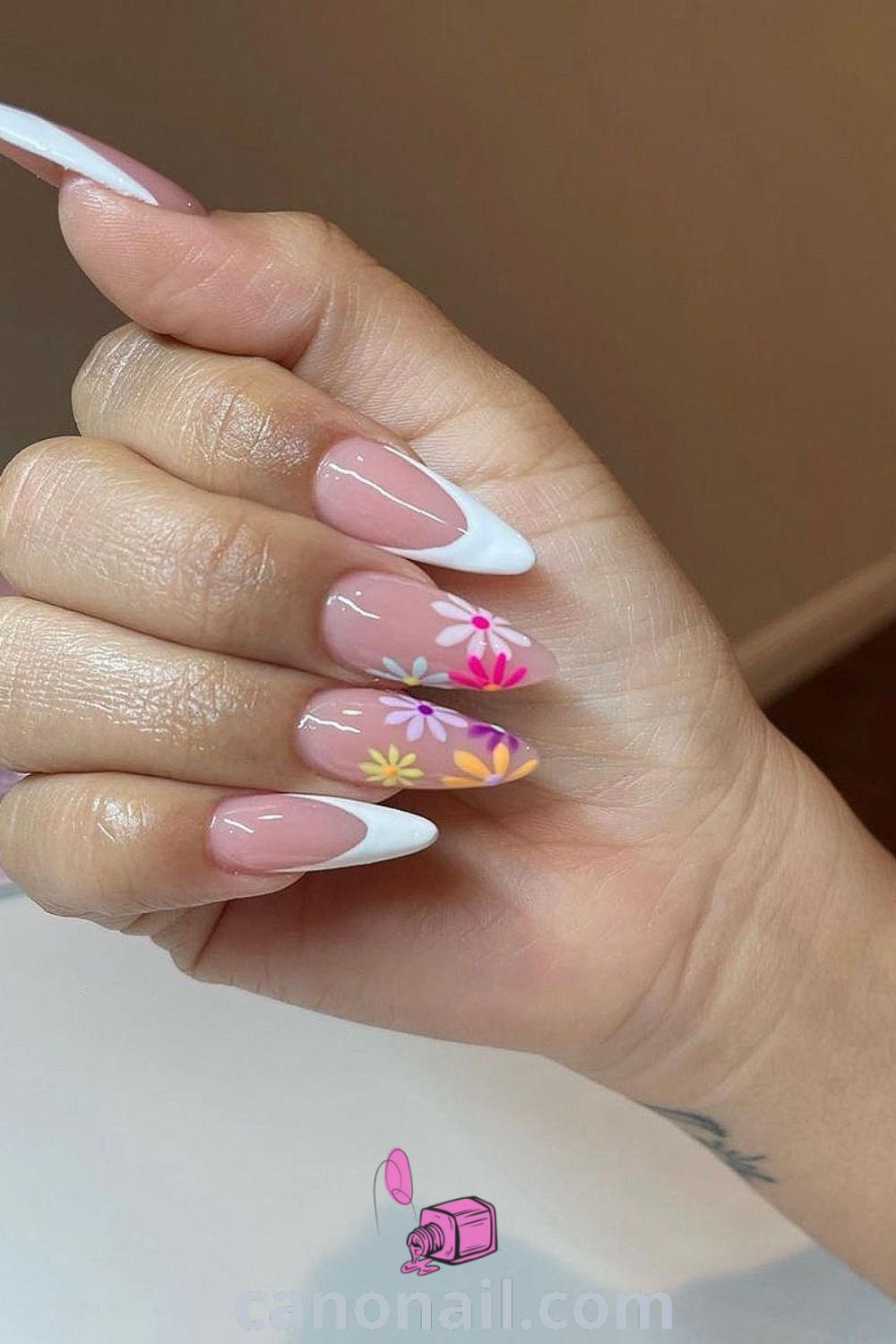 Spring nails on almond-shaped nails showcasing pretty nude colors, shimmering designs, and minimalistic styles. Perfect for a trendy summer manicure. Discover more sophisticated nail ideas at canonail.com.