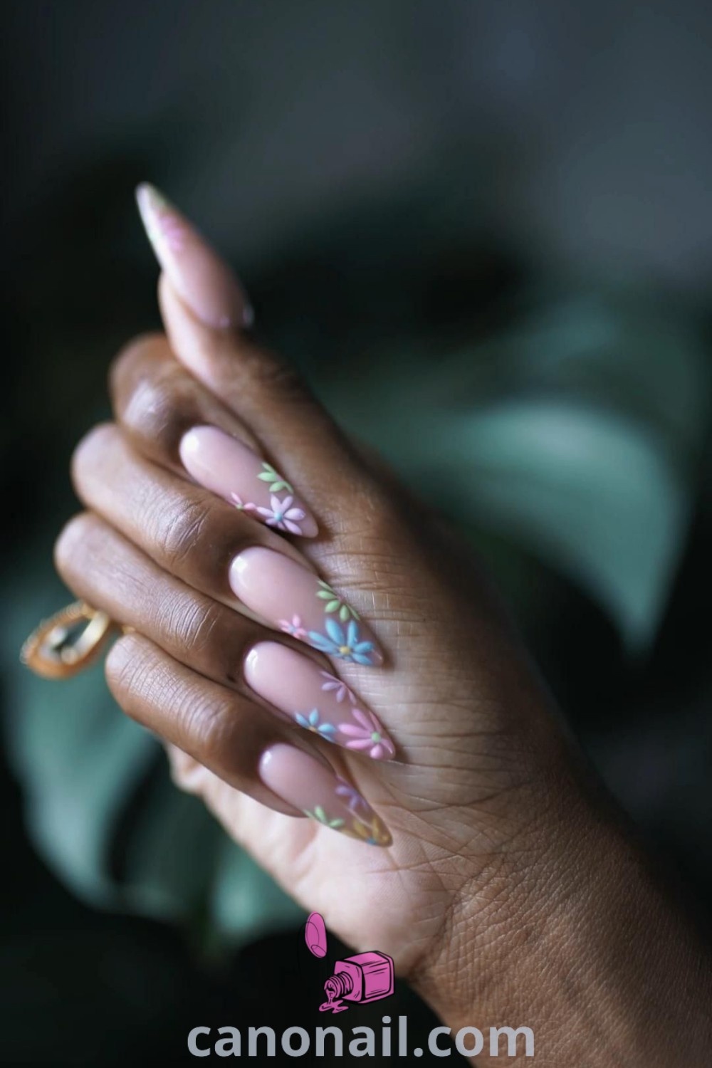 Spring nails featuring almond-shaped nails adorned with multi-color neutral tones, abstract designs, and elegant drip patterns. Discover trendy manicure ideas and modern nail inspiration at canonail.com.