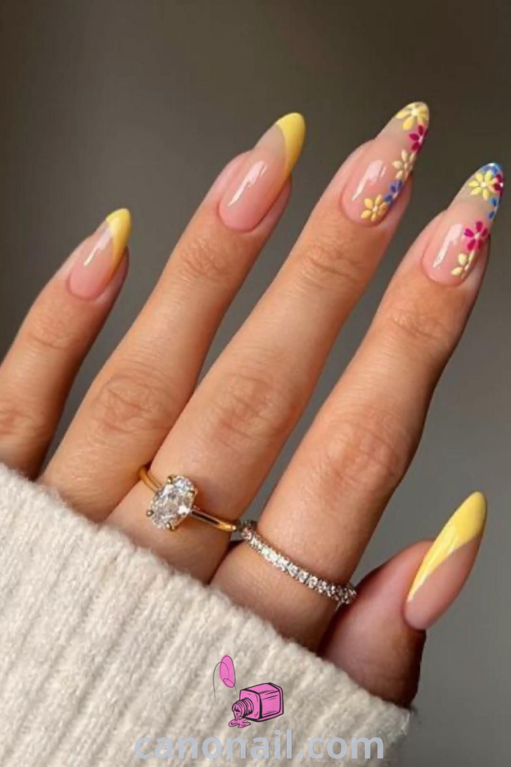 Spring nails in long almond shape with bright yellow acrylics, floral designs, and stunning nail art ideas. Perfect for embracing the spring season, check out more on canonail.com.