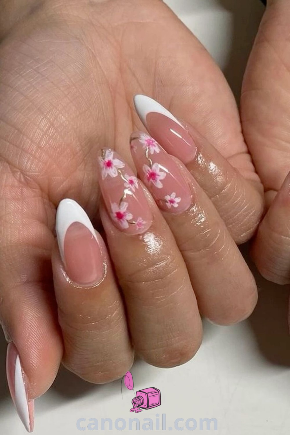 Spring nails featuring cute designs for almond nails, including pink flowers nail art and a creative French tip style with cherries. Perfect for spring, this elegant manicure is filled with trendy inspiration. Discover beautiful nail ideas at canonail.com.