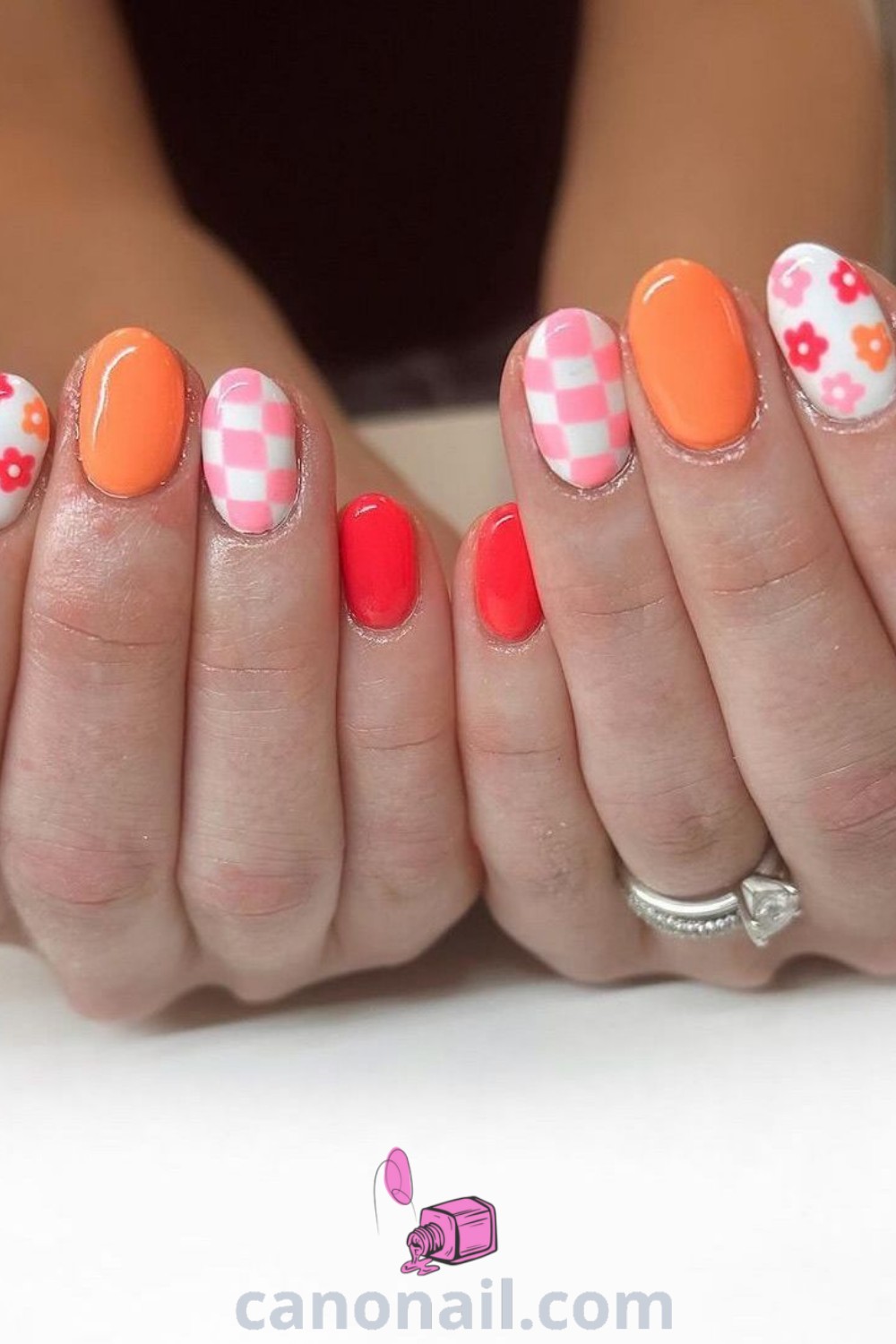 Spring nails featuring almond shape with orange floral designs, pink and orange combinations, and trendy short designs. Explore modern nail ideas and stunning nail looks at canonail.com.