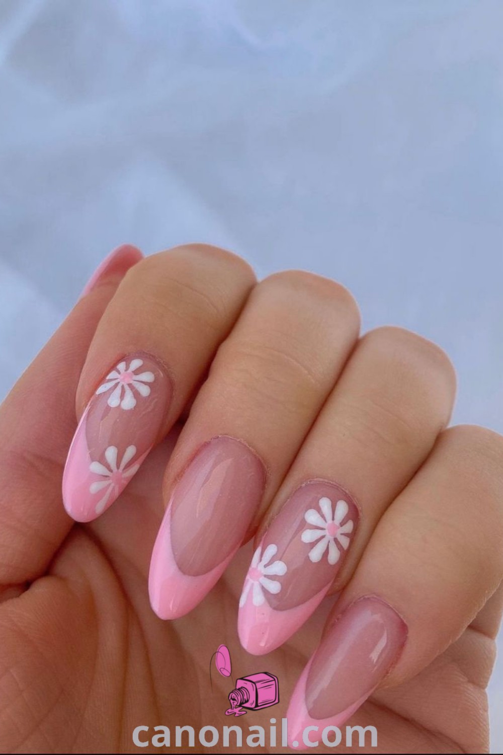 Spring nails featuring almond-shaped acrylic designs with pink flowers and floral nail art for a trendy and beautiful look. Discover more nail inspiration and ideas at canonail.com.