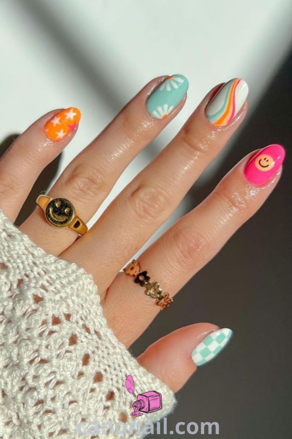 Groovy spring nails on almond-shaped nails featuring colorful patterns, funky bright designs, and retro aesthetics. A fun and trendy manicure that embodies the essence of spring. Explore more nail ideas at canonail.com.