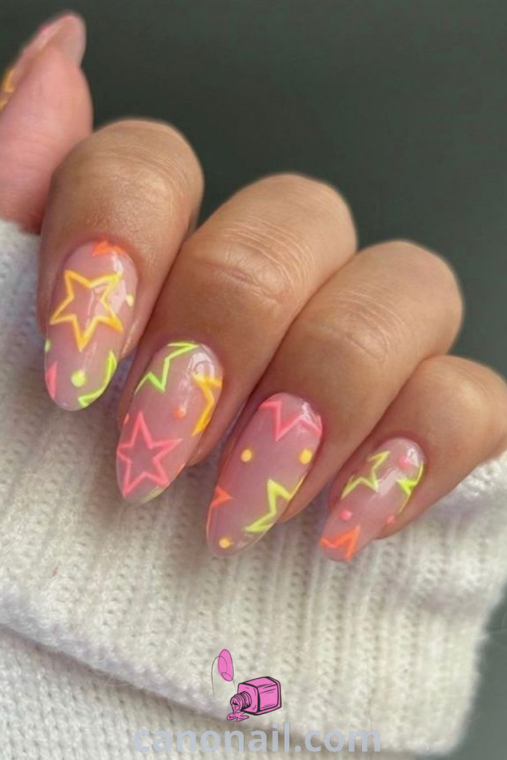 Spring nails featuring neon star designs on almond-shaped nails. Dive into vibrancy with trendy manicure ideas that include summer star nail designs and neon nails inspiration. Explore beautiful nail ideas at canonail.com.
