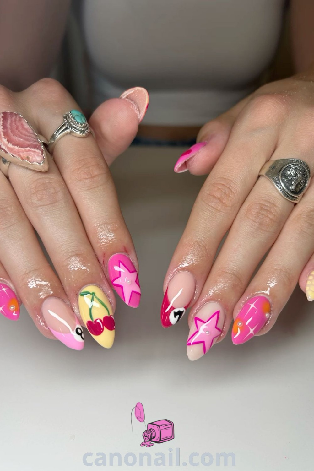 Spring nails featuring almond-shaped mix match designs with colorful patterns and pastel hues, inspired by Miley Cyrus. Explore elegant nail ideas and stunning nail looks at canonail.com.