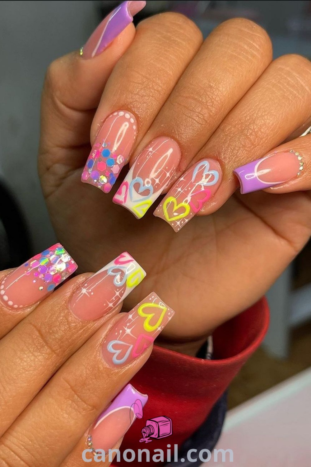 Spring nails featuring happy face nail art on square nails with colorful designs and Lisa Frank elements. Perfect for Easter celebrations, these cute and trendy manicure ideas are sure to inspire your next stunning nail look. Discover more at canonail.com.